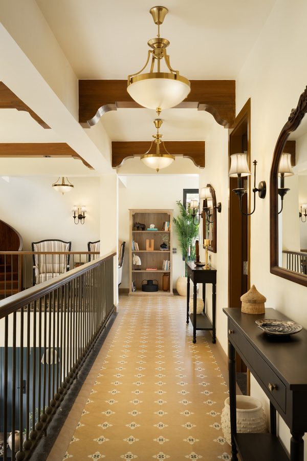 Heritage corridor with brass pendant lights and patterned tiles