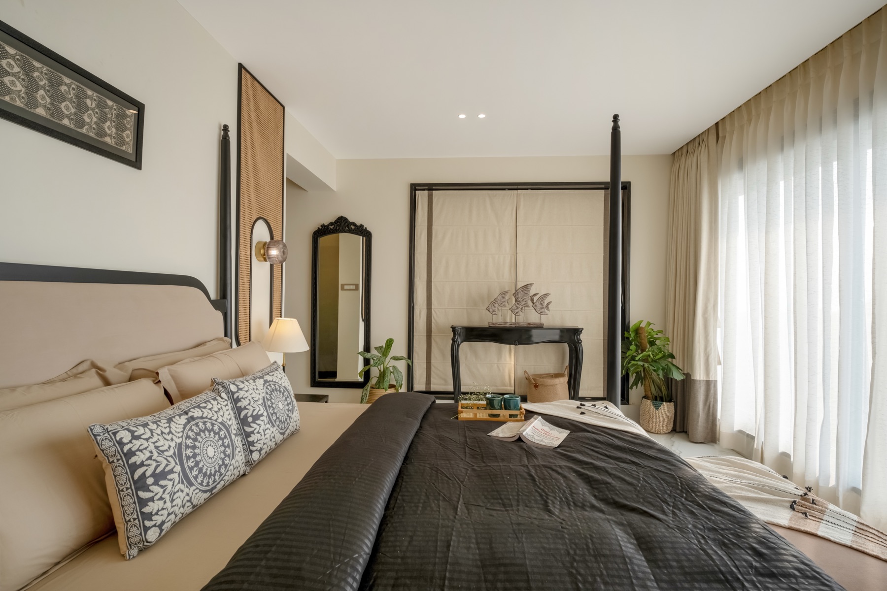 Four-poster bedroom looking past the bed to the standing mirror and console