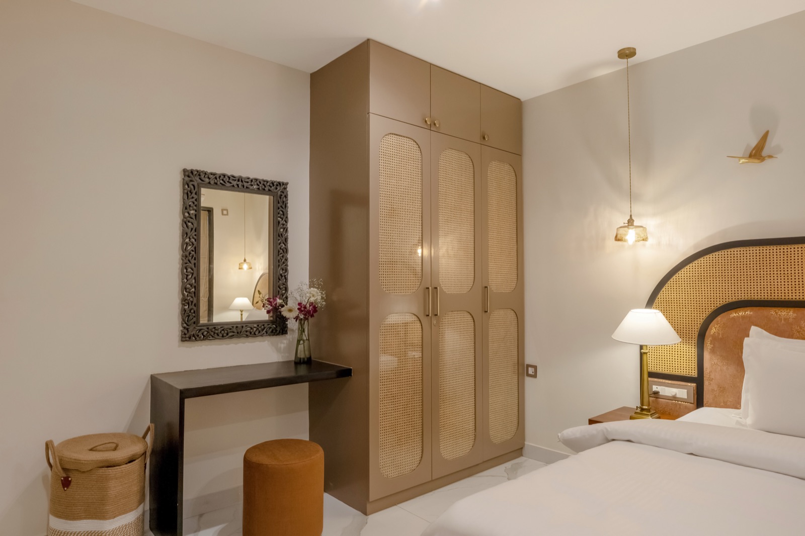 Dressing corner with carved mirror, cane wardrobe and console